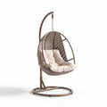 Hanging chair with cushion in brown rattan and steel frame for indoor or outdoor use